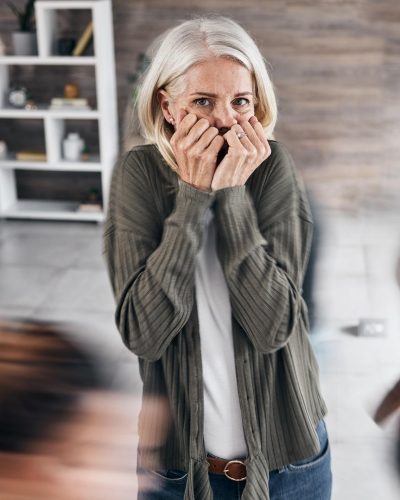 Anxiety, schizophrenia and woman in mental health problem, crisis and fear in busy office or workpl
