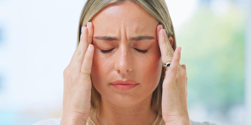 Business, woman and headache in office with stress, burnout and risk in corporate company from migr