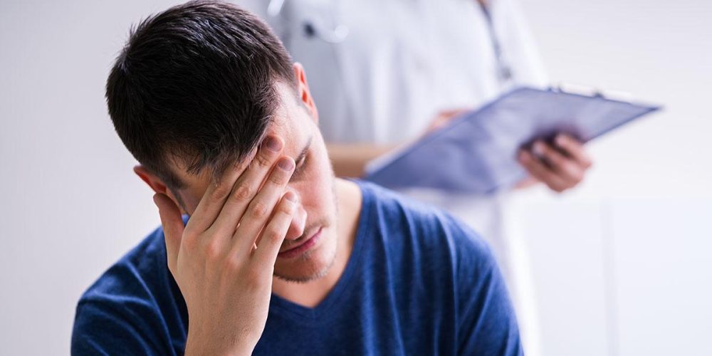 Male Patient With Headache In A Clinic