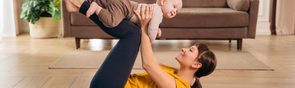 Postpartum recovery. Mommy practicing yoga with her baby