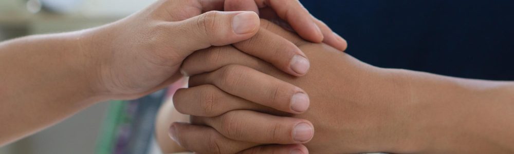 PTSD Mental health concept, Psychologist touch hand young depressed man for encouragement.